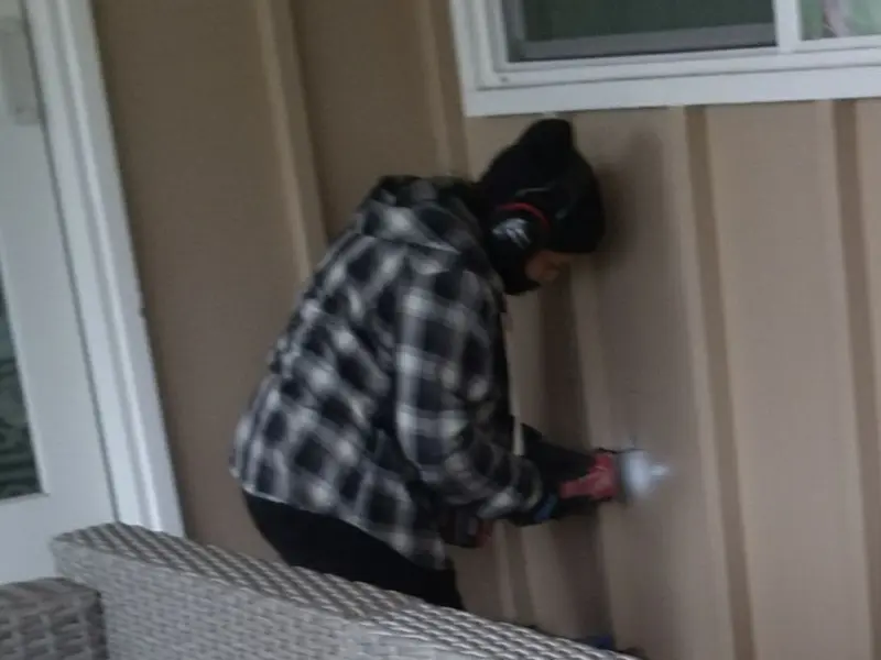 Professional electrician installing an exterior outlet in Sugar Land